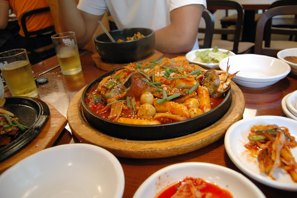 Spicy Korean food with kimchi on the side.